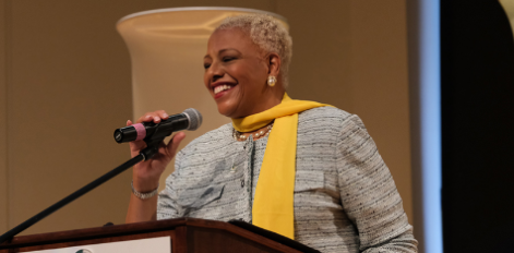 Faculty speaking on podium with microphone