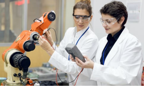 Electronics Engineering students conducting tests on a piece of machinery