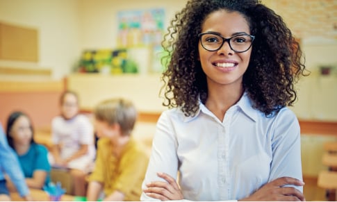 Educator with crossed arms with blurred background