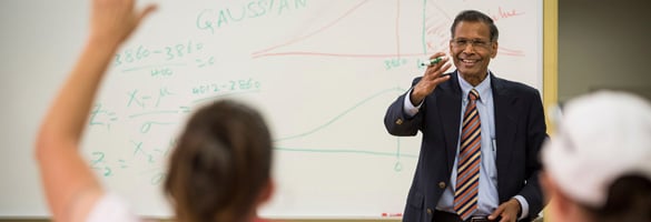 Professor calling on student with their hand raised